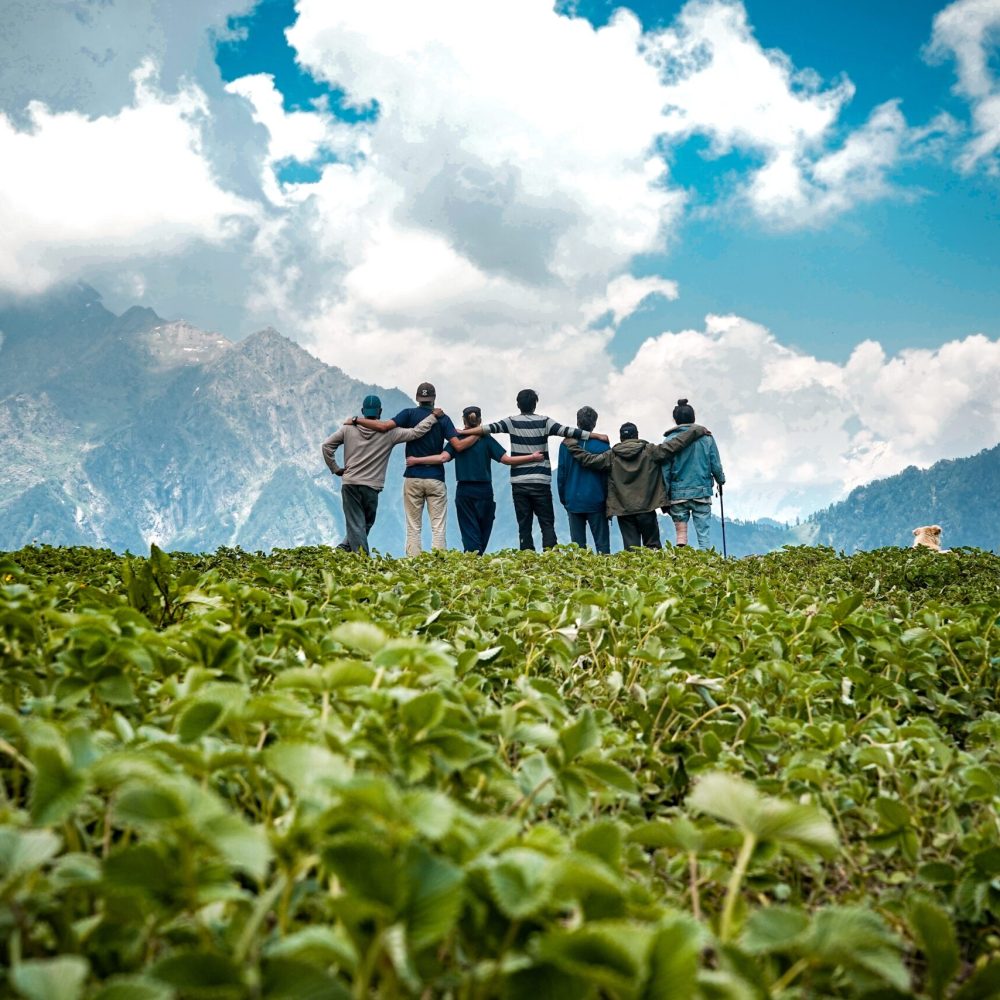 The young friends on top of a mountain enjoying the mesmerizing view
